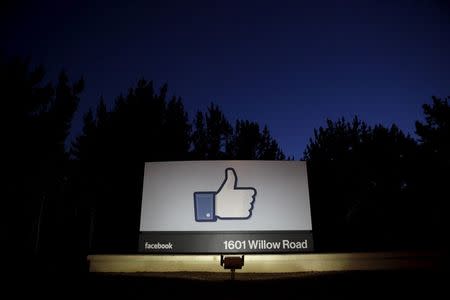 The sun rises behind the entrance sign to Facebook headquarters in Menlo Park before the company's IPO launch, May 18, 2012. REUTERS/Beck Diefenbach/Files