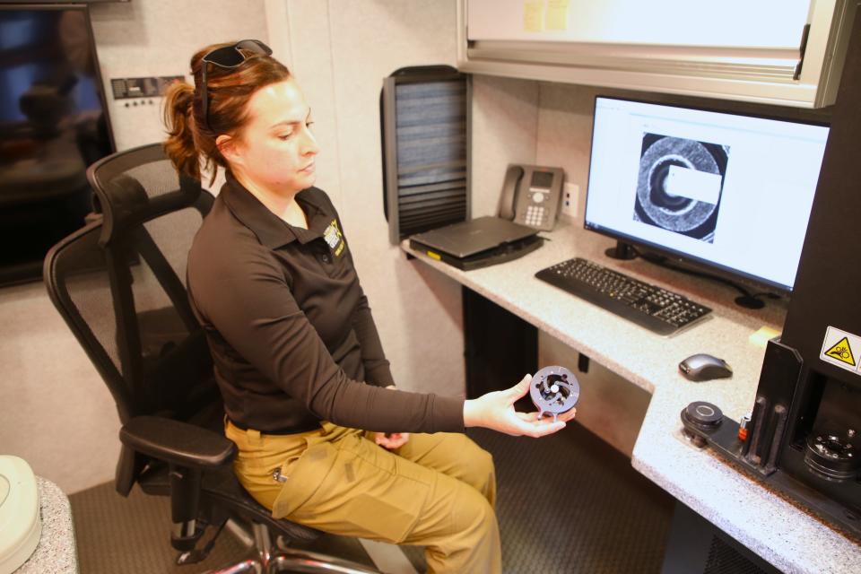 Katie Mason, a crime scene investigator with the San Juan County Sheriff's Office, displays a shell casing in the National Integrated Ballistics Information Network mobile unit on Monday, May 13, 2024 at the sheriff's office Lee Acres station.