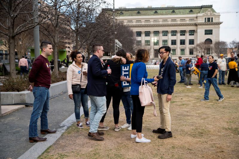 Supporters react to reports of Democratic 2020 U.S. presidential candidate former South Bend, Indiana Mayor Pete Buttigieg suspending his candidacy as they gather before a rally in Dallas