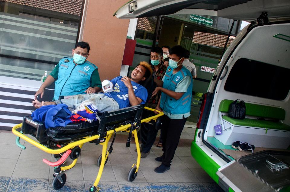 Paramedics transport an injured soccer fan during a soccer match riot at a hospital near Kanjuruhan stadium in Malang, East Java, 02 October 2022 (EPA)