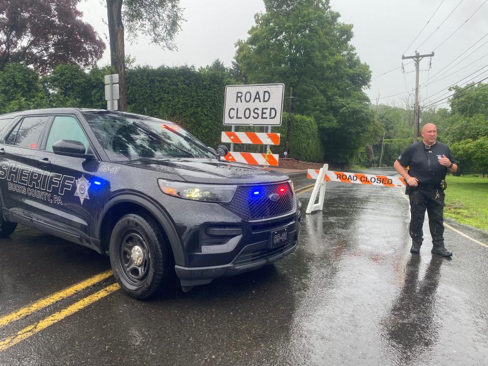 Sgt. Charles Golder, of the Bucks County Sheriff’s Department, mans a roadblock on Washington Crossing Road at the intersection of Wrightstown Road in Upper Makefield on Sunday, July 16, 2023.