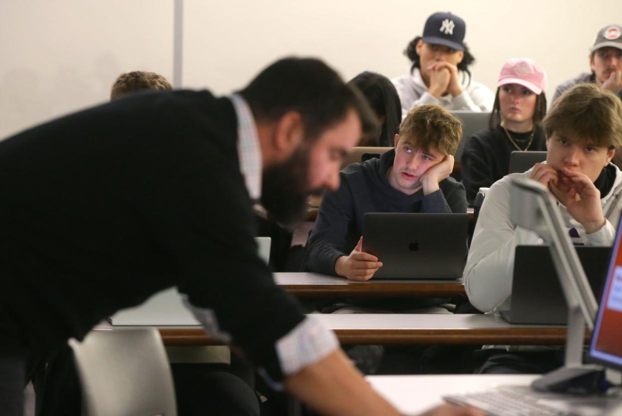 Students listen during Cameron Ellis’ Principles of Risk Management class at the University of Iowa.