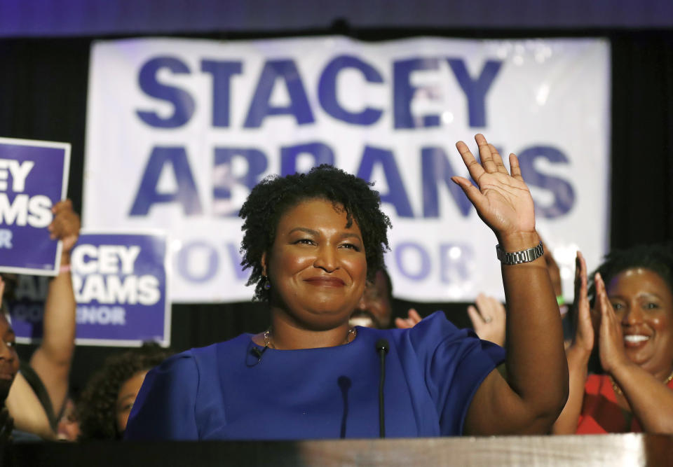 FILE- In this May 22, 2018, file photo Democratic candidate for Georgia Gov. Stacey Abrams waves at a campaign event in Atlanta. Over the course of a year, Stacey Abrams has transformed from a technocratic leader in the Georgia legislature into a nationally known symbol of the Democratic Party’s future. (AP Photo/John Bazemore, File)