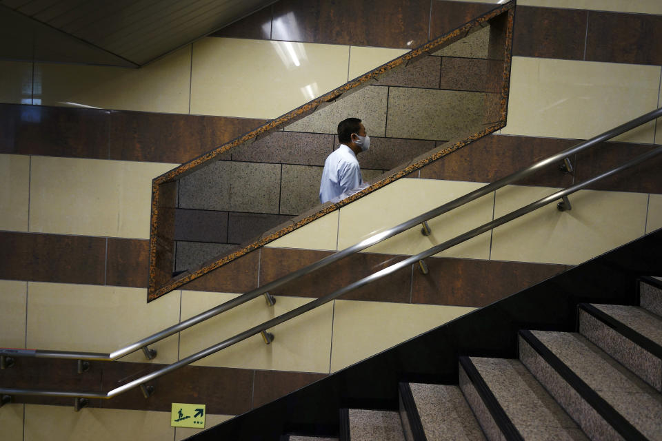 A man wearing a face mask to help curb the spread of the coronavirus walks at an underpass in Tokyo Tuesday, May 12, 2020. Japan is still under a coronavirus state of emergency, which was extended this week until the end of May, though there have been no hard lockdowns. (AP Photo/Eugene Hoshiko)