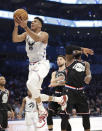 CORRECTS TO THE LAKERS, NOT THE CAVALIERS - Team Giannis' Giannis Antetokounmpo, of the Milwaukee Bucks, moves past Team LeBron's LeBron James, of the Los Angeles Lakers, during the first half of an NBA All-Star basketball game, Sunday, Feb. 17, 2019, in Charlotte, N.C. (AP Photo/Chuck Burton)