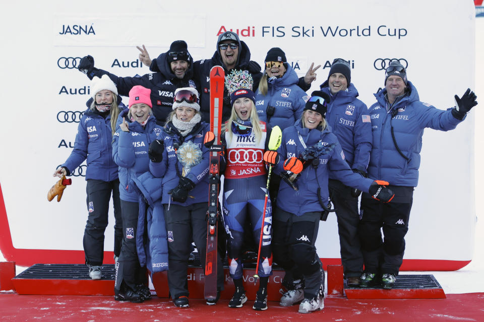 United States' Mikaela Shiffrin, center, celebrates with the team after winning an alpine ski, women's World Cup slalom race, in Jasna, Slovakia, Sunday, Jan. 21, 2024. (AP Photo/Giovanni Maria Pizzato)