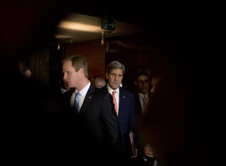 U.S. Secretary of State John Kerry (C) walks to a meeting during nuclear talks between Iran and global powers in Geneva November 9, 2013. REUTERS/Jason Reed