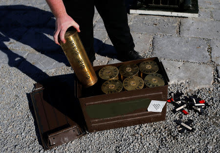 A worker places cartridges of artillery shells in the box after members of the Royal Gibraltar Regiment fired a 21-gun salute to mark the 67th anniversary of Britain's Queen Elizabeth's accession to the throne, in front of the Rock in the British overseas territory of Gibraltar, historically claimed by Spain, February 6, 2019. REUTERS/Jon Nazca