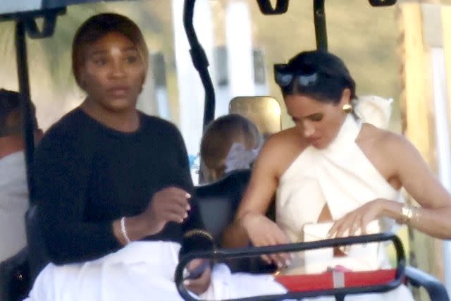 <p>BACKGRID </p> Meghan Markle and Serena Williams sit in a golf cart together in Florida on April 12