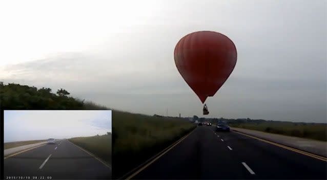 The hot air balloon became ridiculously close to a major highway.