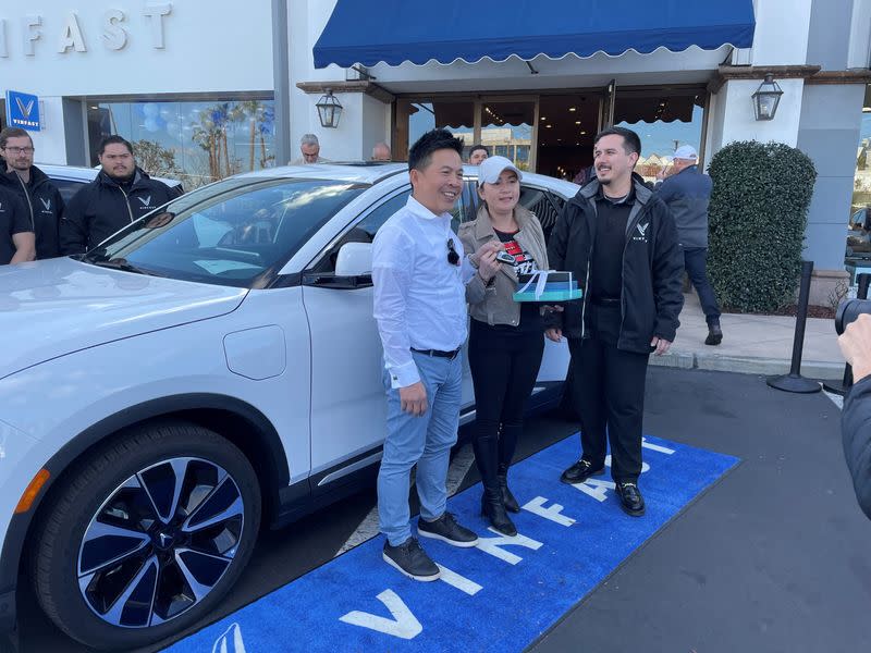 Buyers Andrew and Nikki Le take delivery of their VinFast electric car in Los Angeles
