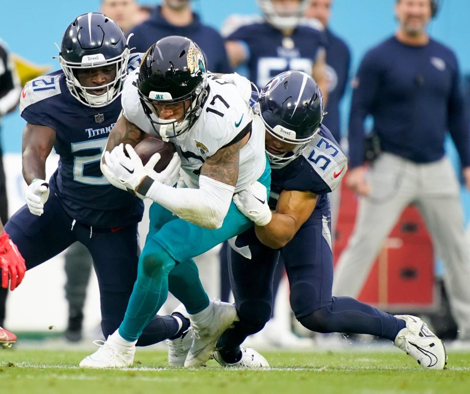 Jacksonville Jaguars tight end Evan Engram (17) is tackled by Tennessee Titans linebacker Dylan Cole (53) during the second quarter at Nissan Stadium Sunday, Dec. 11, 2022, in Nashville, Tenn. 