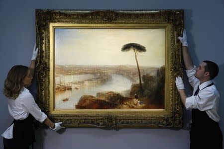 Sotheby's employees pose with British artist J.M.W. Turner's artwork "Rome, from Mount Aventine" at Sotheby's auction house in London November 28, 2014. REUTERS/Luke MacGregor