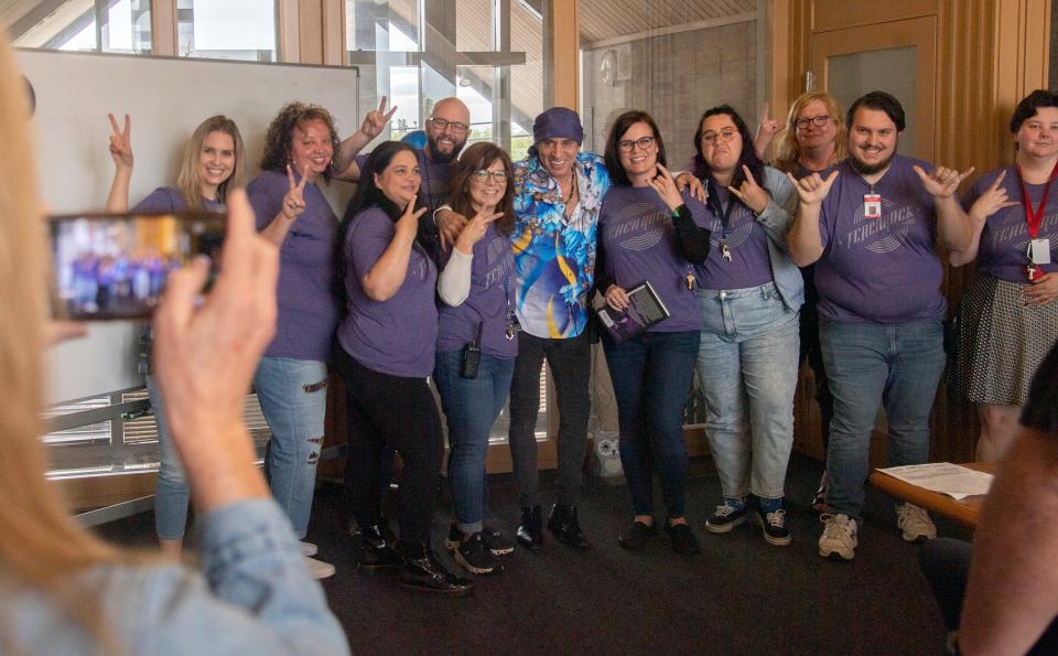 Stevie Van Zandt, guitarist for Bruce Springsteen's E Street Band, center, poses for a pciture with teachers during a visit to John McCandless STEM Charter School in Stockton. Van Zandt launched the TeachRock program, used by the school, to combine music with teaching of other subject.