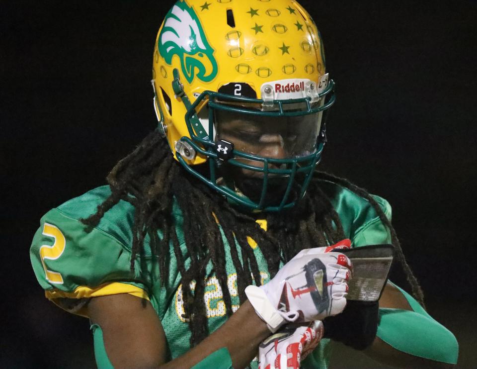 Eastern Alamance receiver Ce'Darion Williams looks to his wristband for a play against Jacksonville.