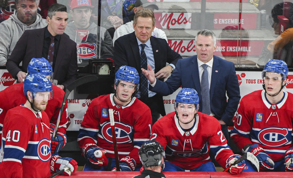 Montreal Canadiens head coach Martin St. Louis, back right, argues with an official following a double minor penalty awarded to the Dallas Stars during third period NHL hockey action in Montreal, Canada, Saturday, Feb. 10, 2024. (Graham Hughes/The Canadian Press via AP)