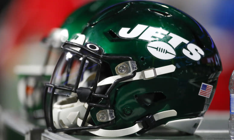 A picture of two Jets helmets sitting side-by-side.