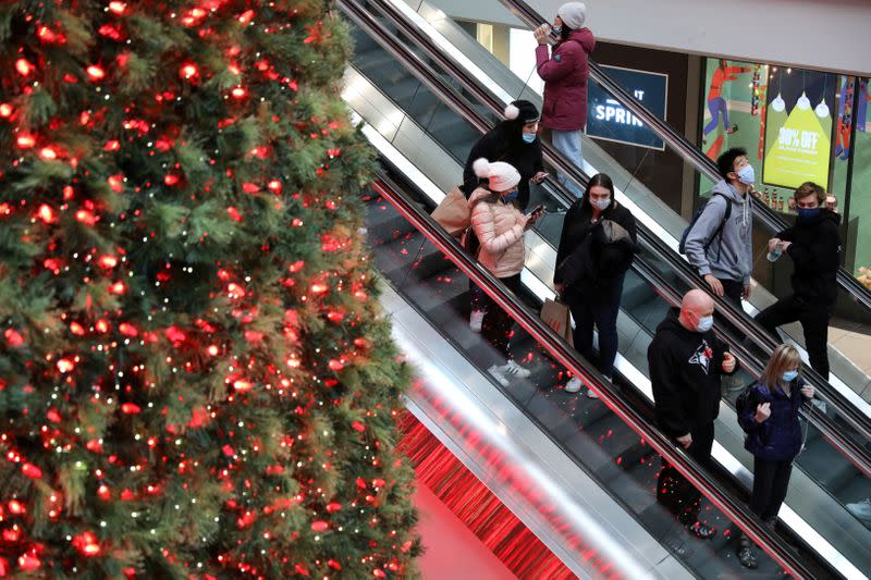 FILE PHOTO: Shoppers wearing mandatory masks pass Christmas Tree at Eaton Centre mall in downtown Toronto