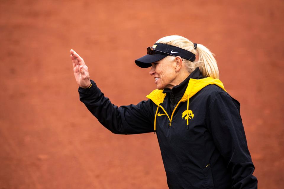 Iowa head coach Renee Gillispie offers up a high-five to a base runner during a NCAA Big Ten Conference softball game against Wisconsin, Friday, March 25, 2022, at Bob Pearl Field in Iowa City, Iowa.