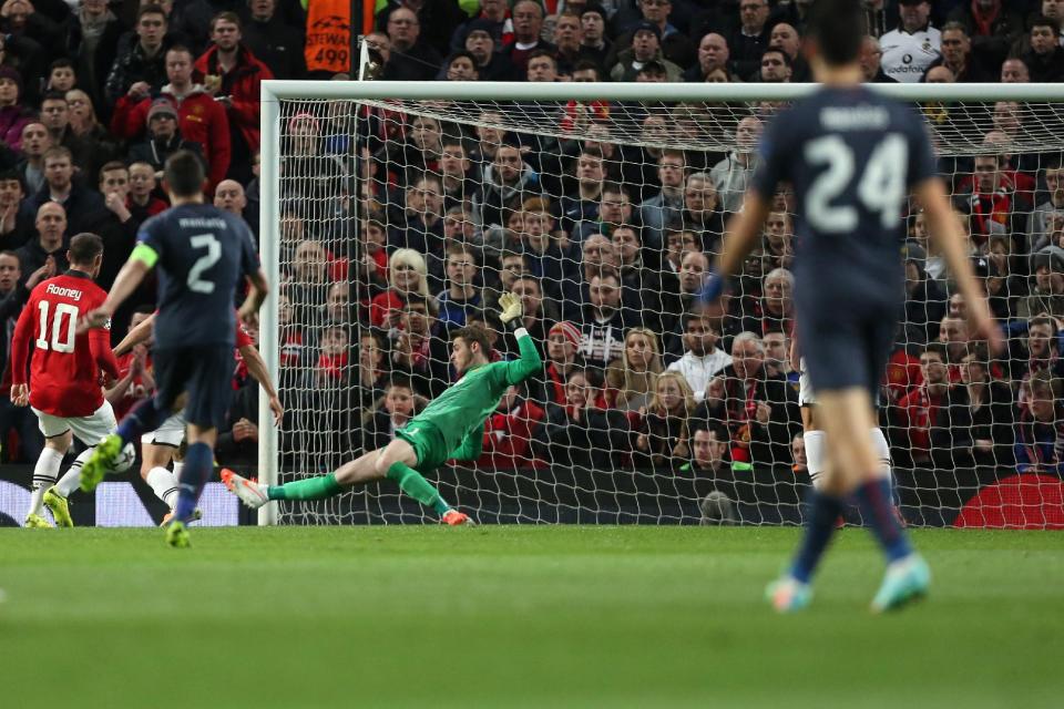 Manchester United's goalkeeper David De Gea, centre left, makes a save, during his team's 3-0 win against Olympiakos in their Champions League last 16 second leg soccer match at Old Trafford Stadium, Manchester, England, Wednesday, March 19, 2014. (AP Photo/Jon Super)