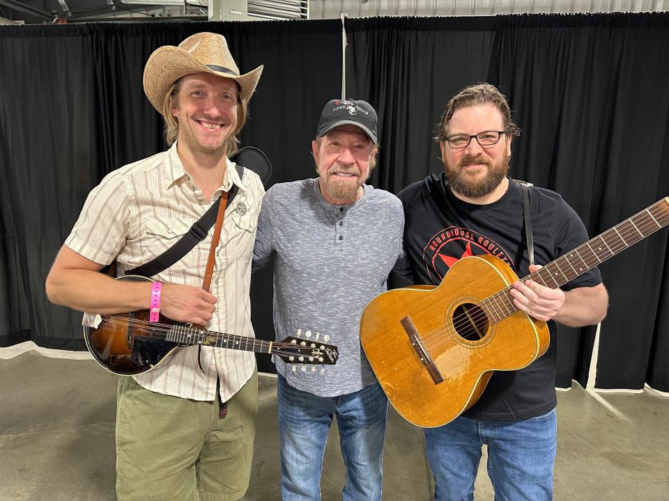 Chuck Norris, center, poses with the Tennessee Warblers, John Beck, left, and Adam Dalton, at Nashville Comicon in June 2023