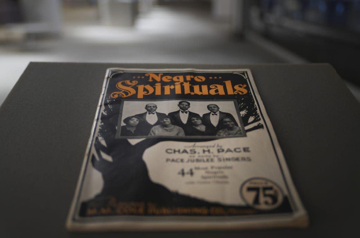 One of the only surviving books of gospel spirituals composed and published by Charles Henry Pace, part of his archive together with photo negatives of sheet music and printing places, is seen at the University of Pittsburgh on Tuesday, Feb. 28, 2023, in Pittsburgh. A project led by the university is highlighting Pace as one of the pioneers of traditional African American gospel with his publishing company being one of the nation’s first to print and disseminate Black gospel music. (AP Photo/Jessie Wardarski)