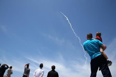 People watch as the Ground-based Midcourse Defense (GMD) element of the U.S. ballistic missile defense system launches during a flight test from Vandenberg Air Force Base, California, U.S., May 30, 2017. REUTERS/Lucy Nicholson