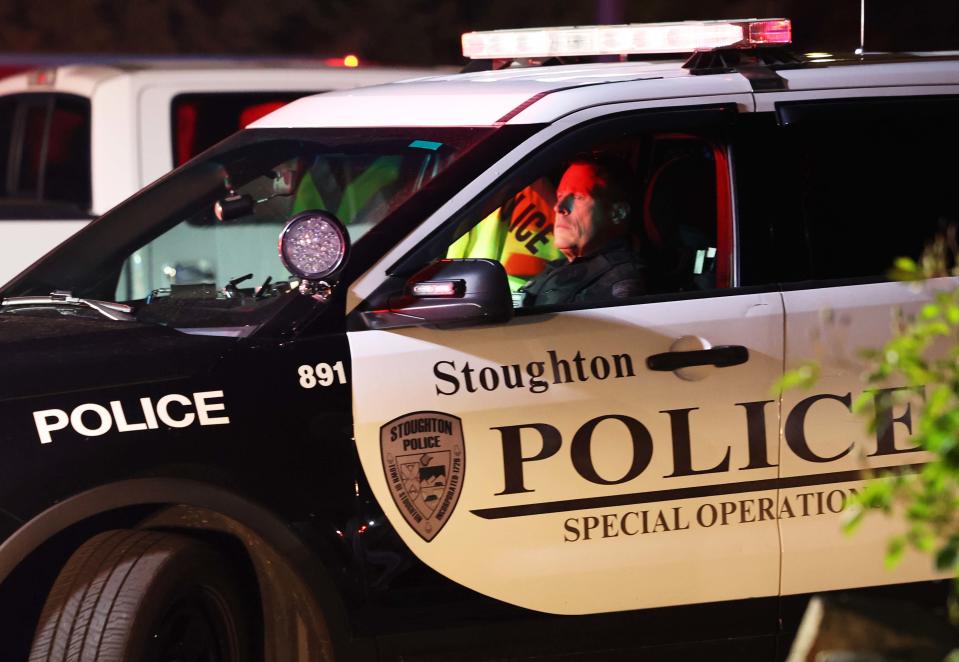 Stoughton police investigate the scene of a serious car crash in which a person was found shot inside the vehicle near the intersection of Plain and West streets on Wednesday, May 24, 2023.