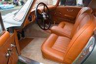 <p>The interior trim door cards were missing, along with the carpets and the original colour of the trim, but a small sample of original ochre tan leather was discovered when the car was stripped down. This was colour matched and the original type and colour leather was used to recreate the interior. </p>