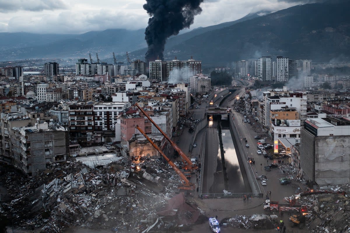 After: Smoke billows from the Iskenderun Port as rescue workers work at the scene of a collapsed building on February 07, 2023 in Iskenderun, Turkey (Getty)