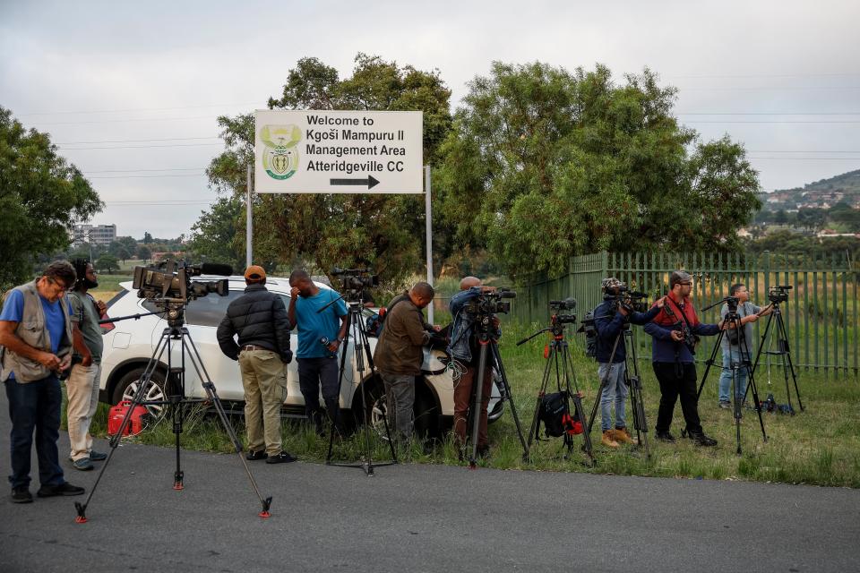 Journalists set up at the entrance of the Atteridgeville Correctional Centre in Pretoria on 5 January 2024 (AFP via Getty Images)