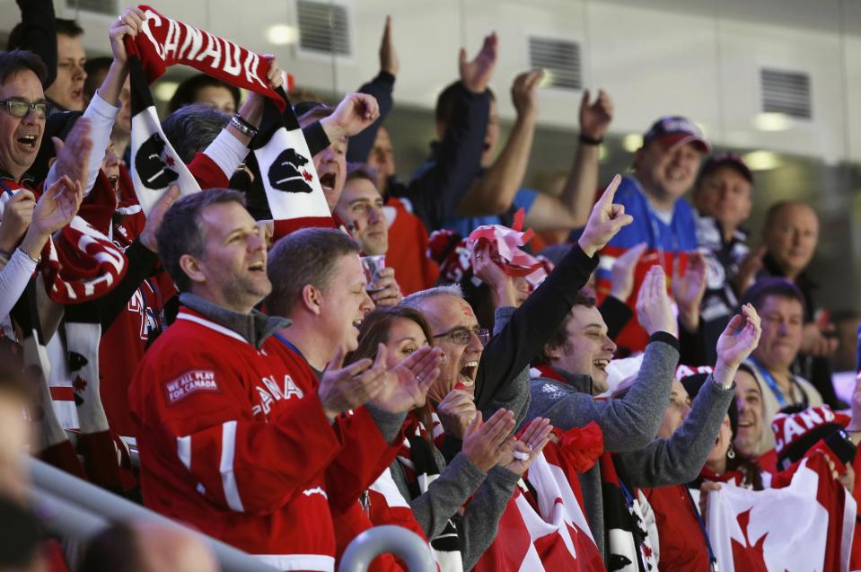 Canadian supporters cheer during their men's ice hockey gold medal game against Sweden at the Sochi 2014 Winter Olympic Games February 23, 2014. REUTERS/Grigory Dukor (RUSSIA - Tags: SPORT ICE HOCKEY OLYMPICS)