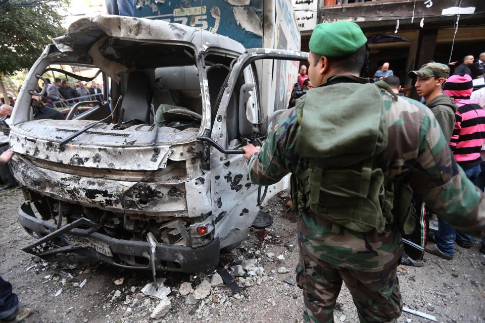 A Lebanese army soldier looks at a damaged truck at the site of a car bombing in the southern suburb of Beirut, Lebanon, Tuesday, Jan. 21, 2014. A car bomb ripped through a Shiite neighborhood in southern Beirut killing several people and setting plumes of smoke over the area in the latest attack targeting supporters of the militant Hezbollah group in Lebanon. (AP Photo/Hussein Malla)