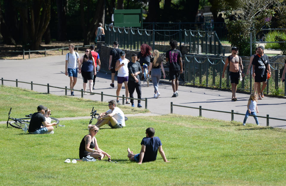 BOURNEMOUTH, ENGLAND - MAY 29: People enjoy the hot weather in the town park on May 29, 2020 in Bournemouth, United Kingdom. The British government continues to ease the coronavirus lockdown by announcing schools will open to reception year pupils plus years one and six from June 1st. Open-air markets and car showrooms can also open from the same date.  (Photo by Finnbarr Webster/Getty Images)