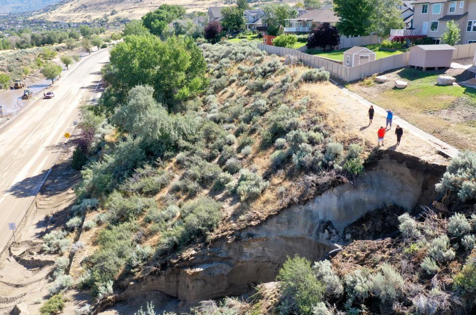 People look at the aftermath of a mudslide near the intersection of 1300 East and Highland Drive in Draper on Friday, Aug. 4, 2023. Draper Mayor Troy Walker declared a state of emergency due to flooding. | Kristin Murphy, Deseret News
