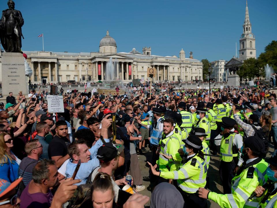 Conspiracy theorists, including Q believers, clash with police at an anti-lockdown protest in Trafalgar Square, London, on Saturday 19 September 2020AFP/Getty