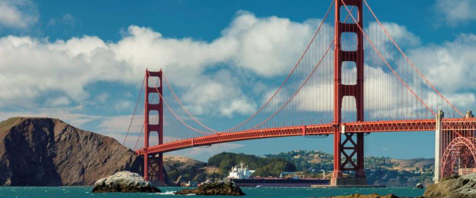 Golden Gate Bridge at sunset seen from San Francisco beach, California.