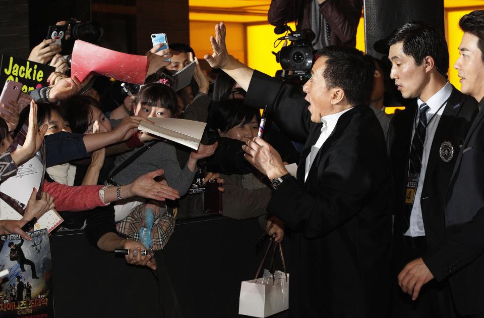 Hong Kong actor and director Jackie Chan, third from right, and South Korean actor Kwon Sang-woo, right, are greeted by fans during a promotional event for their latest movie, CZ12, or Chinese Zodiac, in Seoul, South Korea, Monday, Feb. 18, 2013. (AP Photo/Ahn Young-joon)