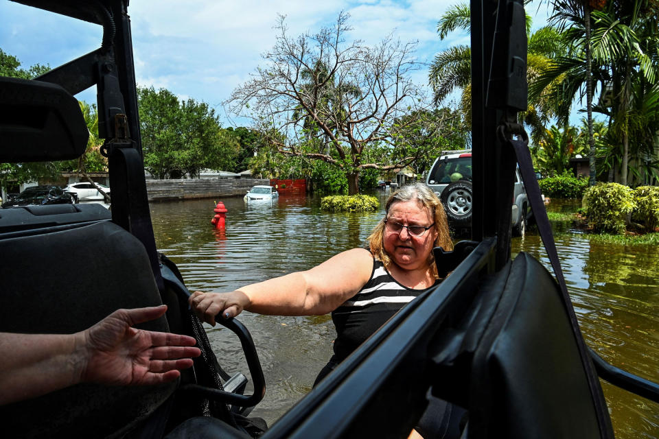 A woman is rescued by Florida Fish and Wildlife Conservation law enforcement in Fort Lauderdale, Fla., on April 13, 2023.<span class="copyright">Chandan Khanna—AFP/Getty Images</span>