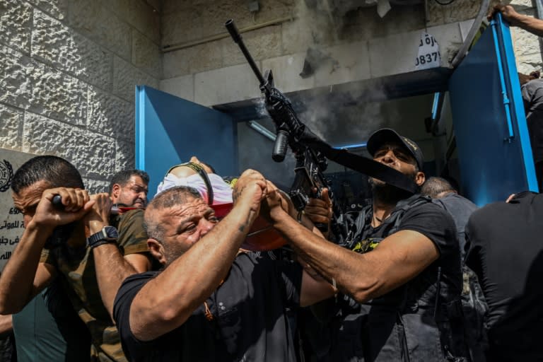 Several of the bodies were draped in flags and marched by crowds of Palestinians, including armed militants, through the streets (RONALDO SCHEMIDT)