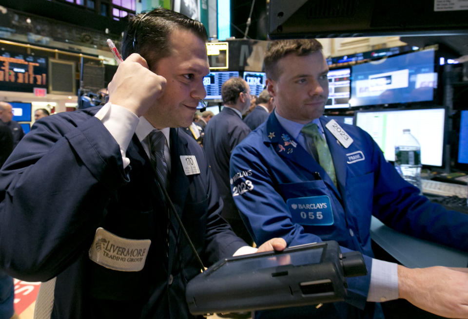 Trader Michael Zicchinolfi, left, and specialist Frank Masiello work on the floor of the New York Stock Exchange, Thursday, April 3, 2014. Stocks indexes are edging higher as investors become more optimistic about the outlook for the U.S. economy. (AP Photo/Richard Drew)