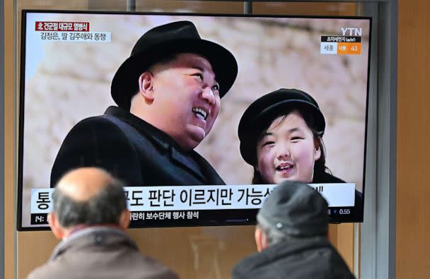 PHOTO: People watch a television screen showing a news broadcast with an image of North Korean leader Kim Jong Un and his daughter attending a military parade held in Pyongyang, at a railway station in Seoul on Feb. 9, 2023. (Jung Yeon-je/AFP via Getty Images)