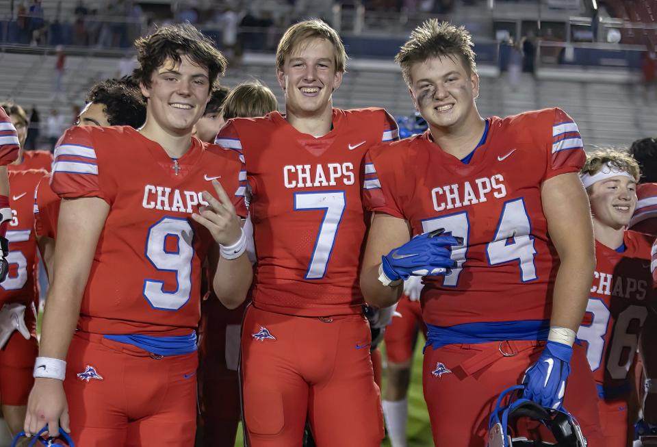 Westlake offensive lineman Tyler Knape, right, standing with quarterbacks Rees Wise, left, and Paxton Land, said Hasson inspires the Chaparrals. He said Hasson knows the names, numbers and positions of every player.