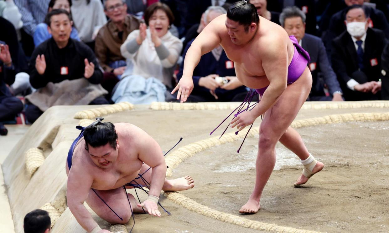 <span>Sumo wrestler Takerufuji defeats Gonoyama on the final day of the spring Grand Sumo tournament in Osaka, Japan.</span><span>Photograph: Jiji Press/EPA</span>