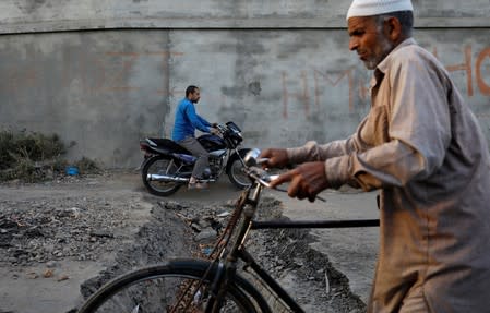 The Wider Image: Barricades and books in restive Kashmir neighbourhood