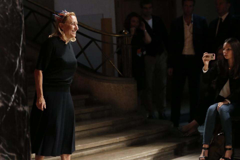 Designer Miuccia Prada acknowledges applause following the presentation of the ready-to-wear Spring/Summer 2014 fashion collection she designed for Miu Miu, Wednesday, Oct. 2, 2013 in Paris. (AP Photo/Jacques Brinon)