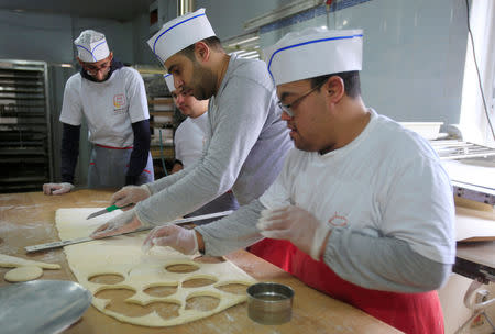 Ali Kerdi, 35, trains special needs students at a bakery in the southern city of Tyre, Lebanon December 18, 2018. Picture taken December 18, 2018. REUTERS/Ali Hashisho