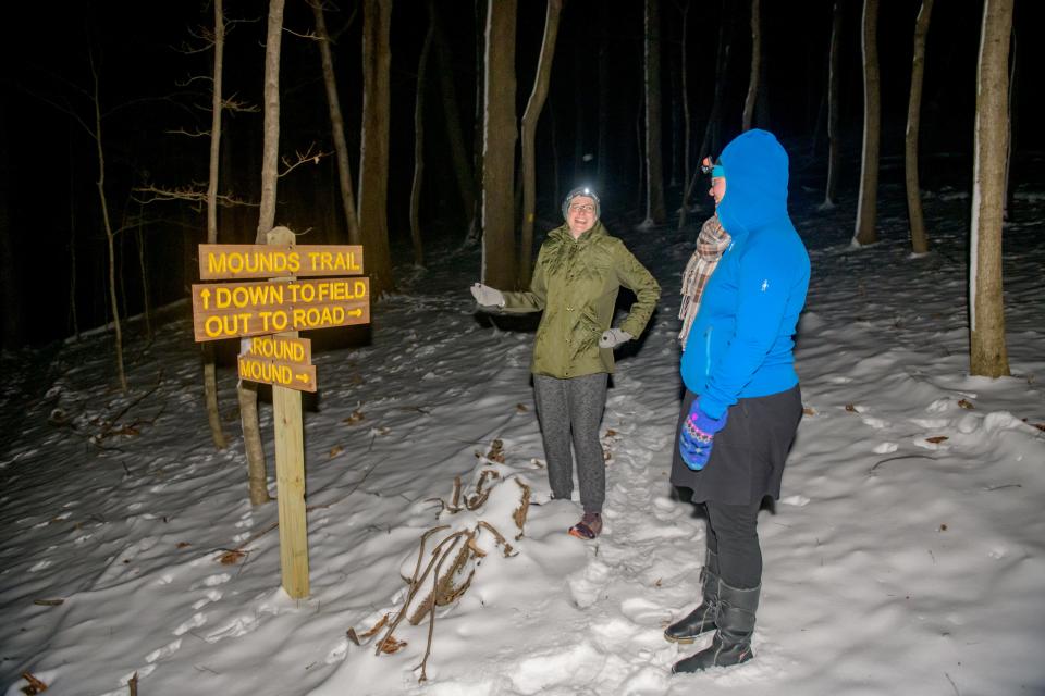 Mary Sue Hosbrough, left, and Jennifer Jacobsen-Wood come to a fork in the path during a recent pre-dawn trek through a new section of Spring Creek Preserve in Fondulac Township.