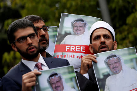 Human rights activists and friends of Saudi journalist Jamal Khashoggi hold his pictures during a protest outside the Saudi Consulate in Istanbul, Turkey October 8, 2018. REUTERS/Murad Sezer