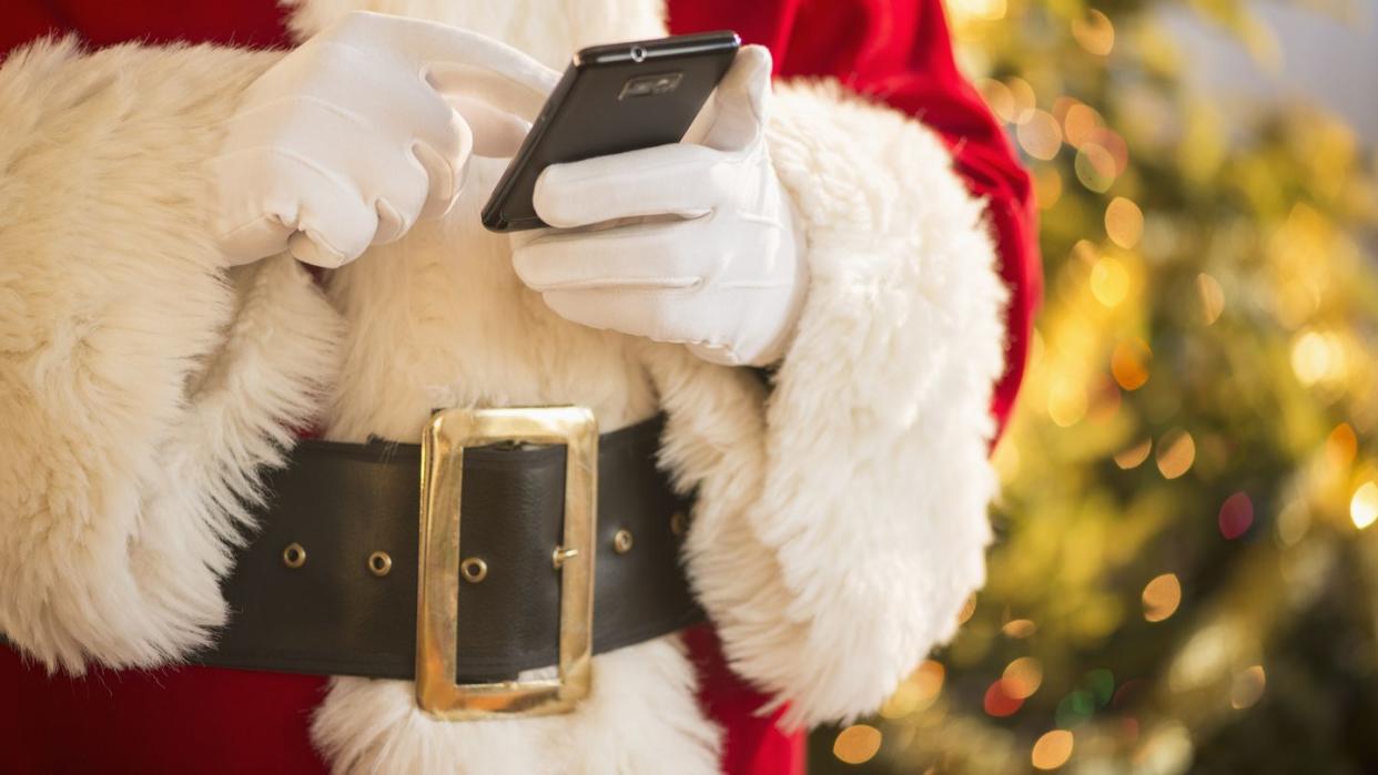 Santa claus holding cell phone